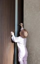 Baby tries to open the door