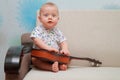 Baby try to play guitar on couch Royalty Free Stock Photo