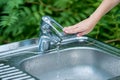 Baby try to turn off water faucet but water still leak. A child`s hand turning off the tap. Save water. World Water Monitoring Da Royalty Free Stock Photo