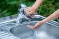 Baby try to turn off water faucet but water still leak. A child hand turning off the tap. Save water. World Water Monitoring Da Royalty Free Stock Photo