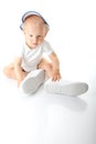 Baby trying on shoes and basebal cap Royalty Free Stock Photo