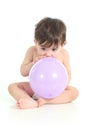 Baby trying to inflate a balloon