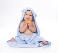 Baby under blue towel on white