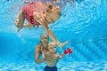 Baby underwater swimming lesson with instructor in the pool Royalty Free Stock Photo