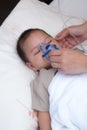 Baby using spacer for respiratory infection