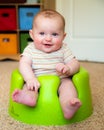 Baby using training Bumbo seat to sit up Royalty Free Stock Photo