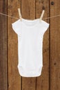 Baby wear hanging in clothespins on washing line Royalty Free Stock Photo
