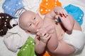 Baby Wearing a Cloth Diaper Surrounded by a Rainbow of Cloth Diapers Royalty Free Stock Photo