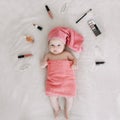 Baby wearing pink towel after bath. Childhood and baby care concept. Portrait of a cute funny girl 2-3 months old Royalty Free Stock Photo