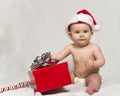 Baby Wearing Santa hat with Christmas Present Royalty Free Stock Photo