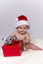 Baby Wearing Santa hat with Christmas Present Royalty Free Stock Photo