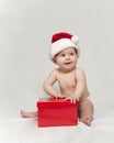 Baby wearing santa Hat with Red Christmas Present Royalty Free Stock Photo