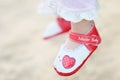 baby wears red shoes on the beach Royalty Free Stock Photo