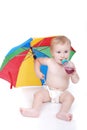 Baby in white with umbrella Royalty Free Stock Photo