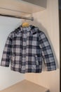 Baby winter jacket gray,a children`s jacket in the closet hangs on the hanger Royalty Free Stock Photo