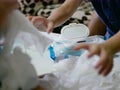 Baby wipes being pulled out from the package all over the table by babies