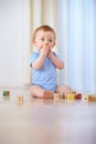 Baby, wooden blocks and playing with toys for early childhood development or youth at home. Little boy, cute toddler or Royalty Free Stock Photo