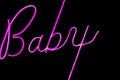 Baby word in proton purple neon color on black background Royalty Free Stock Photo