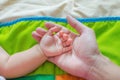 The baby& x27;s hand rests on his father& x27;s hand. Feel the warmth Royalty Free Stock Photo