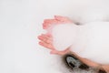 baby& x27;s hands holding bath foam. girl having fun in the bathroom. child bathing. crop view. hygiene, evening routine Royalty Free Stock Photo