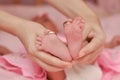 the baby& x27;s legs are in the mother& x27;s hands. gold wedding rings on baby& x27;s toes. family or wedding concept Royalty Free Stock Photo