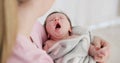 Baby, yawn and calm with tired newborn and mom in a bedroom at morning with care. Rest, relax and young kid with fatigue