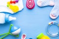 Baby yellow booties. Children's shoes and toys on blue background. Newborn. Royalty Free Stock Photo