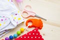 Baby yellow booties. Children's shoes and toys on white wooden boards background. Newborn.