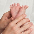 Babyfeet with mamas hands