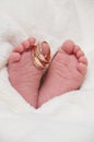 Babyfeet with wedding rings