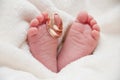 Babyfeet with wedding rings