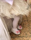 Babygirl on her first birthday party with tulle skirt and slippers