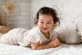 Cute Korean Baby Girl Posing Lying On Stomach At Home