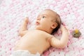 Baby girl in diaper lying with pacifier on blanket Royalty Free Stock Photo