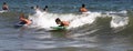 Children riding boogie boards on a wave in the ocean Royalty Free Stock Photo