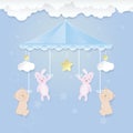 Babymobile with teddy bear, rabbit toy and cloud on blue