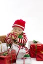 Babys First Christmas Eating Present Royalty Free Stock Photo