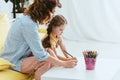 Babysitter and cute kid drawing with Royalty Free Stock Photo