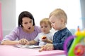 Babysitter reads book to kids Royalty Free Stock Photo