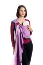 Babywearing attractive young mother with baby in woven wrap carrier. Free hands and active motherhood concept idea