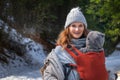 Babywearing mother winter outdoor with copy space