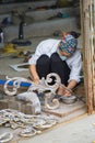 Bac Ninh, Vietnam - Sep 9, 2015: Copper handicraft and fine art products is being made manually by woman worker in Dai Bai traditi