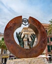 Bacardi Emblem statue frames a rounded stylish building. in rusty brown