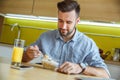 Bachelor man daily routine in the kitchen single lifestyle concept eating breakfast Royalty Free Stock Photo