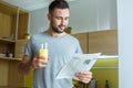 Bachelor man daily routine in a kitchen single lifestyle concept orange juice Royalty Free Stock Photo