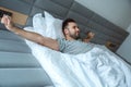 Bachelor man daily routine single lifestyle morning concept awakening stretching