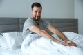 Bachelor man daily routine single lifestyle morning concept awakening stretching sleepy
