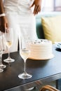 Bachelorette party. Themed cake and champagne glasses on the table with blurred person in the background Royalty Free Stock Photo