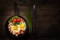 Bachelors dinner - fried egg and sausage on wooden background