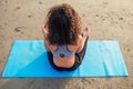 Back of afro america woman with curly hair deep breathing and calming herself on empty morning beach after surya Royalty Free Stock Photo